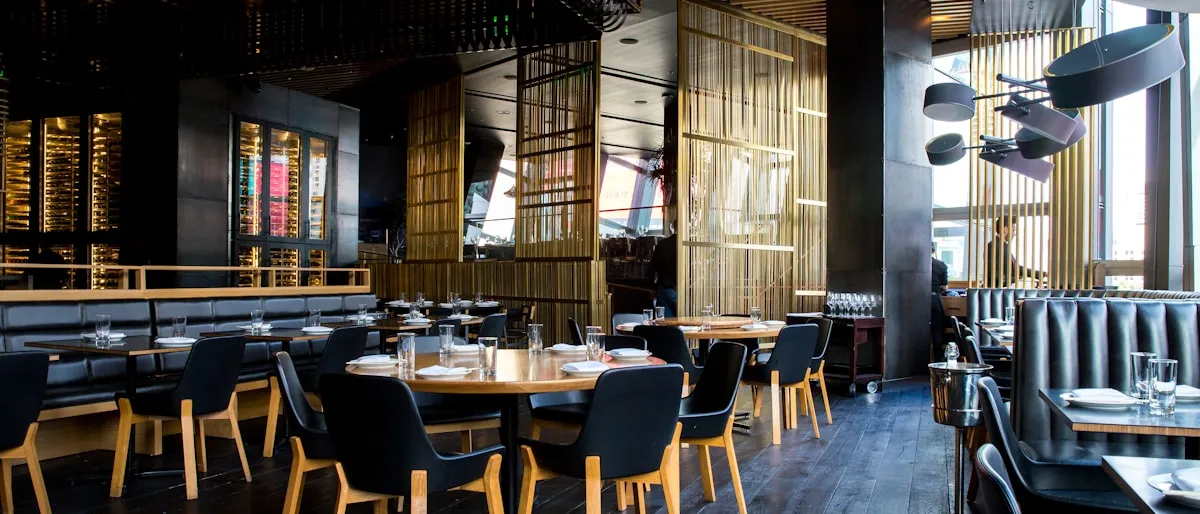 Customer booking a restaurant table online from their smartphone in the evening